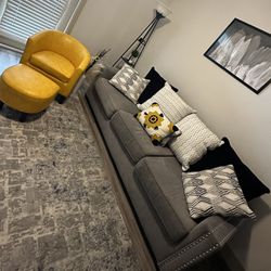 grey couch and yellow upholstered ottoman 