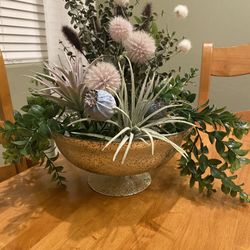 Faux plants / succulents/ poppyseed/ thistle/ cattails mix in gold painted glass pedestal bowl. 
