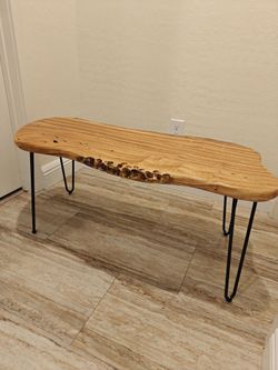 Live edge cedar coffee table and black hairpin legs.