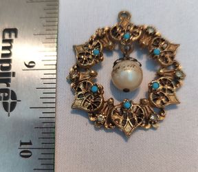 Vintage Florenza gilt brooch features an openwork design set with turquoise cabochons and a dangling faux pearl. 

Pictures are of the actual lot you