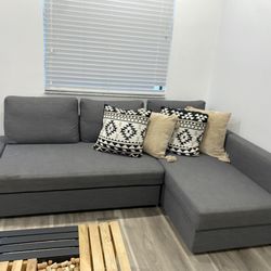 Gray sectional sofa w/ chaise & sleeper and table center