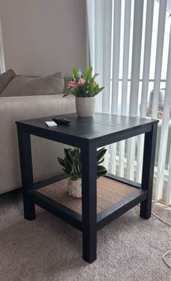 Black side table with wicker detail shelf