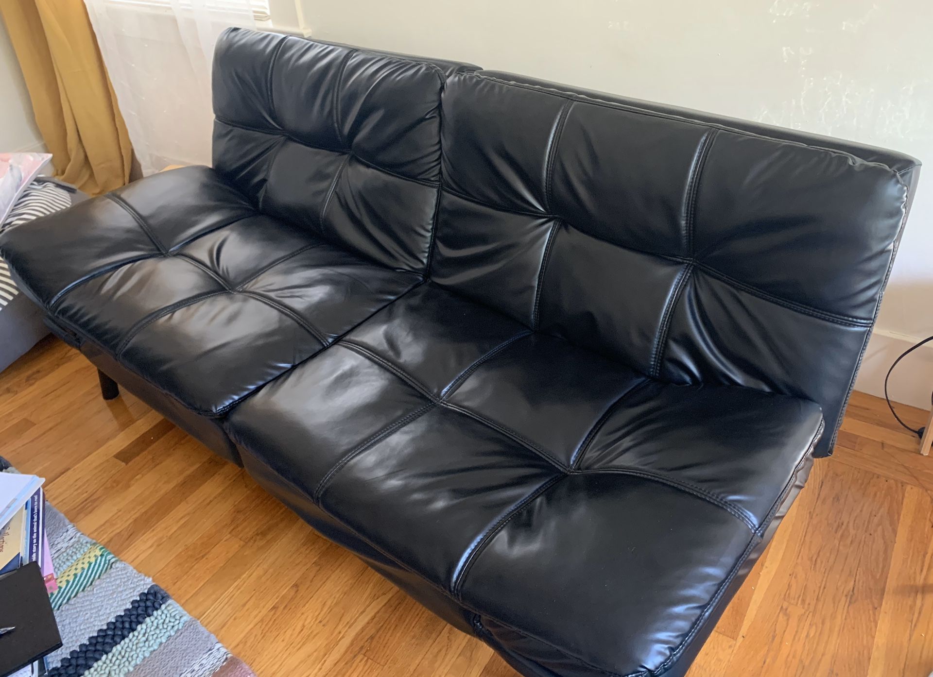 Black faux leather futon -good condition