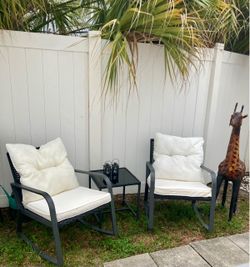 Outdoor set pair rolling chairs and table and cushions