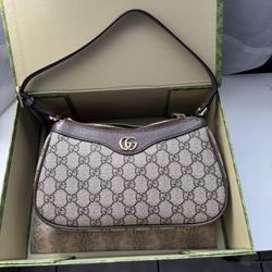 Shoulder gucci bag. Never used. Was a gift to someone. Perfect condition. Brown colorway.