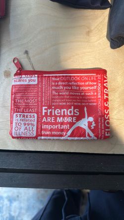 This is a Lululemon red and white manifesto print zipper pouch. 