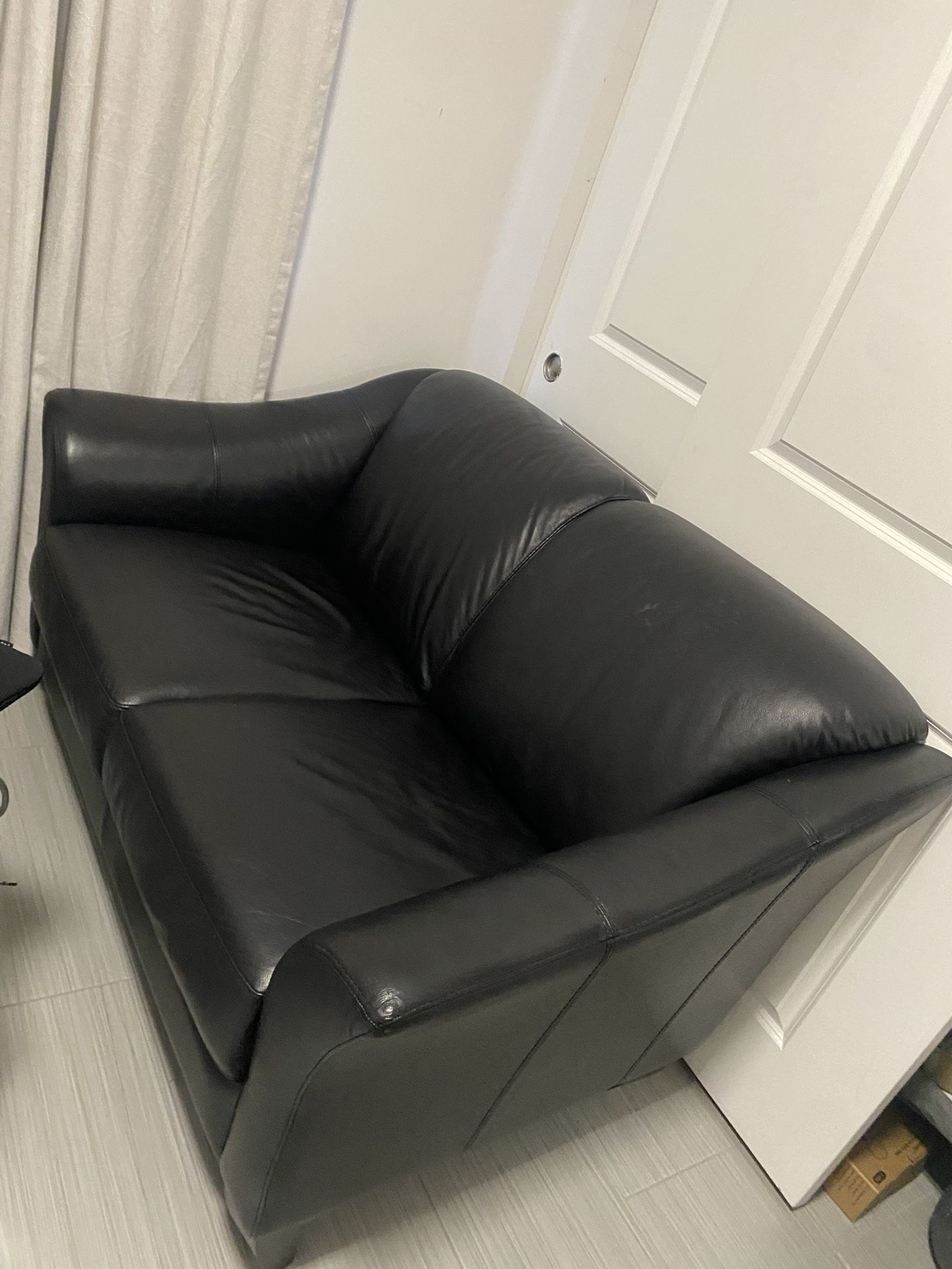 Black faux leather loveseat