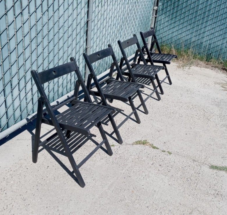 four folding ikea wooden chairs