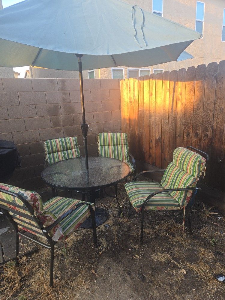 Glass Patio Table With 4 Chairs And Cushions. Umbrella Included