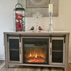 Electric Fireplace Tv Stand New in Original Packaging With Barn Doors Accommodating Tv’s up to 55”.