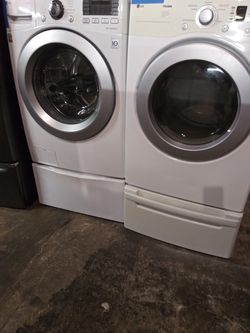 LG front load washer and dryer set with pedestals in excellent conditions
