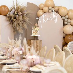 Pampas grass, balloons and artificial flower wall decoration.