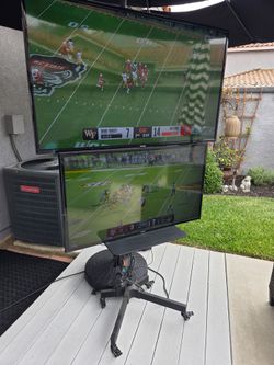 Two TVs with Rolling Floor Stand with Wheels