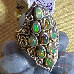 WELO OPAL ELONGATED STERLING SILVER RING. SIZE 6./*9 FACETED STONES*, /(5 X 7.5 MM )EACH LUMINOUS GEMSTONE (R-15094)