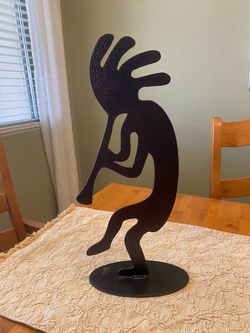 Southwest metal Kokopelli 18 x 8 inch artist marked statue. Rustic. Good condition.