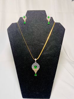pendant set featuring gold and rhodium plating with Austrian crystal