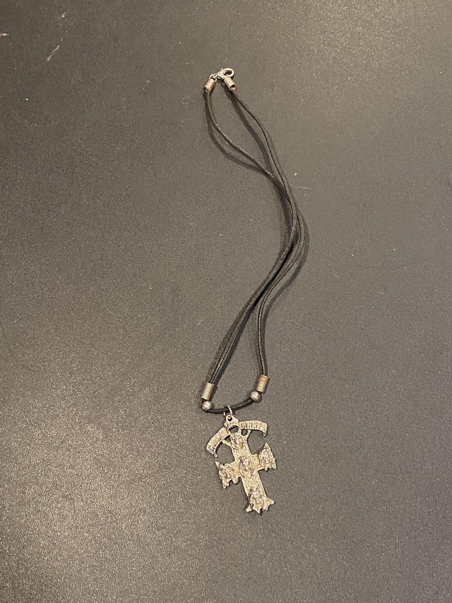 Vintage "Guns N Roses" Charm on cord. Metal charm measures approximately 1.75" x 1.25".