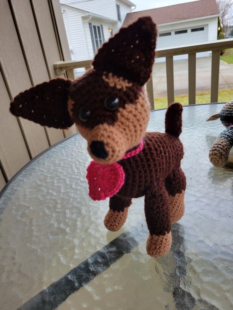 Hand crocheted brown and tan dog with heart collar.