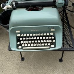 Vintage teal color Typewriter by Royal with cover