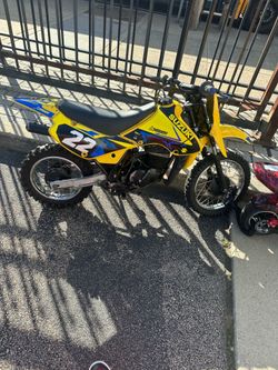 2 stroke Suzuki jr80 dirt bike with racing helmet and 2stroke oil