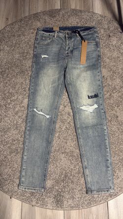 blue with black writing ksubi jeans