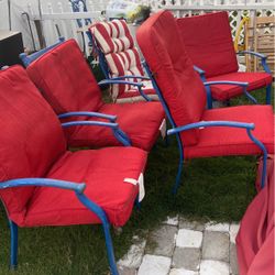 A Nice Outdoor Tablet With Six Chairs And Umbrella 