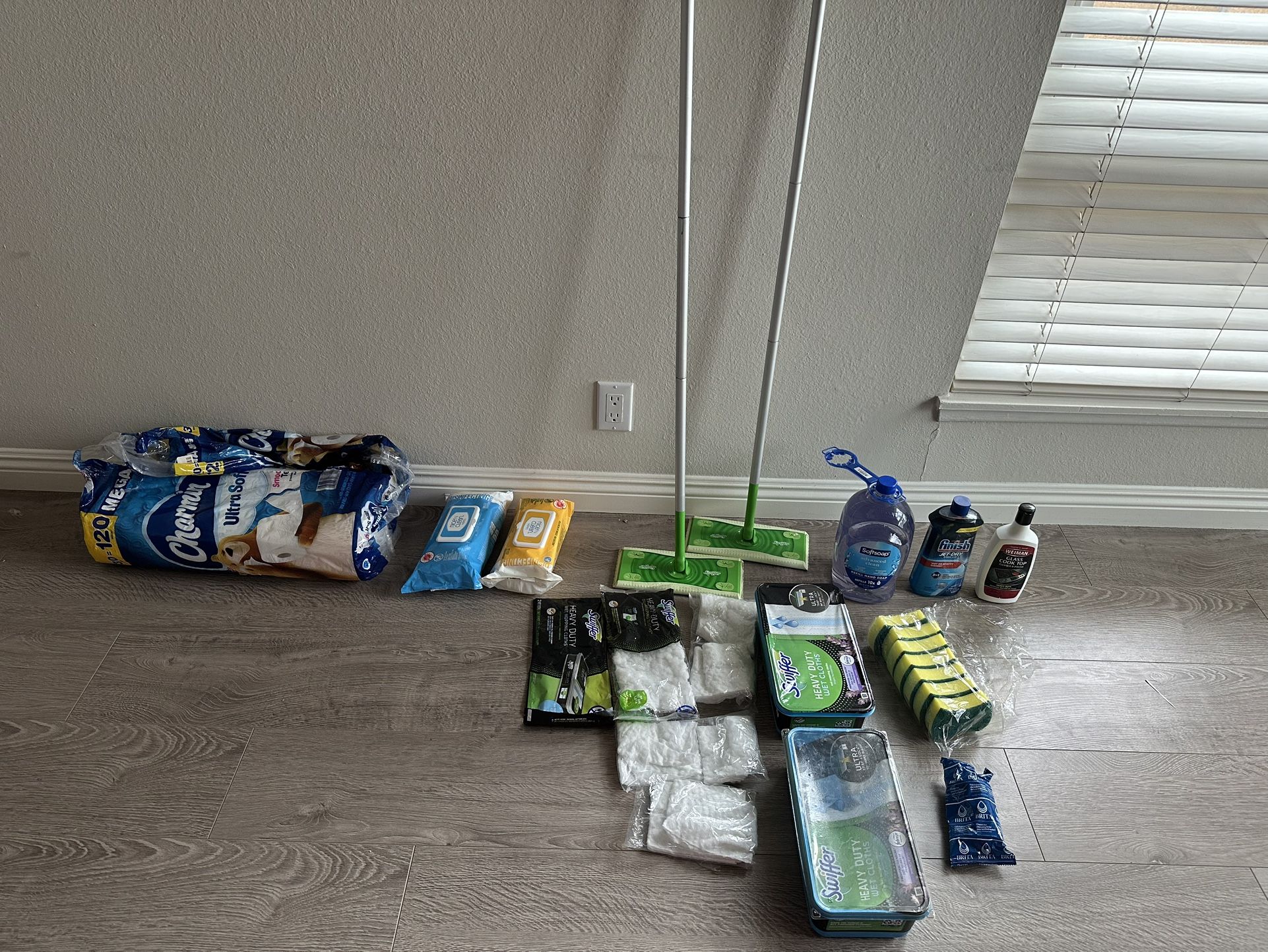New cleaning supplies, swiffer, wet mopping pads, disinfectant wipes, toilet paper rolls, Brita 6M