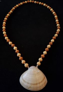 Wood bead shell necklace. Necklae is 24-in. Shell measures 1.75 in long and 2.25 in wide