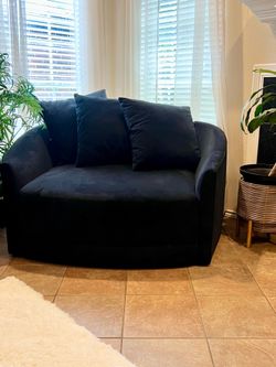 Black oversized swivel cuddler chair