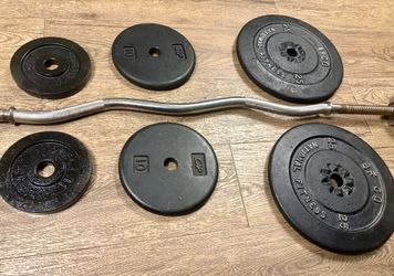 Standard Curl Bar with Cast Iron Weight plates: 25s, 10a and 5s. Total: 97 lbs