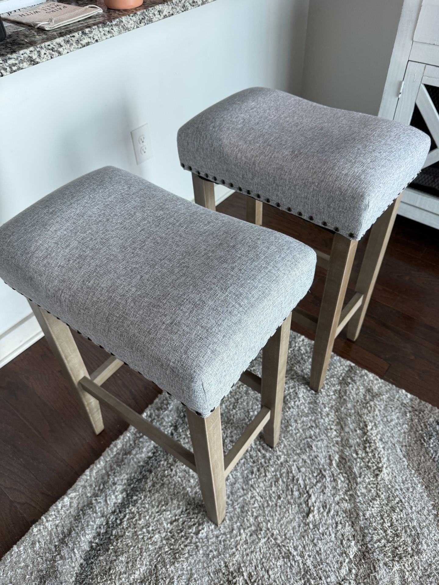 2 Subrtex 24" Backless Bar Stools - Set of 2 Lightly used bar stools with gray upholstered cushions