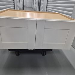 A cabinet placed on top of a refrigerator, especially when part of a cohesive kitchen