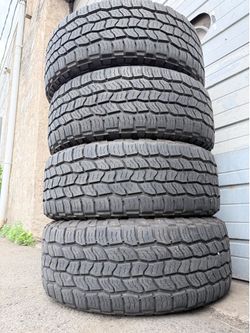 4 USED LT275/55/20 Cooper Discoverer AT3 XLT all-terrain tires.