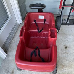  Wagon with two seats and seatbelts and storage area.