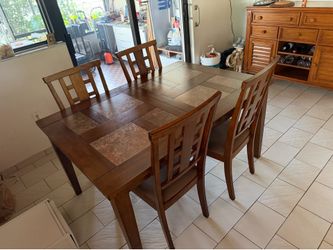 Wood dining room table with chairs.