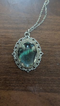 Sliver pendant with butterfly wings