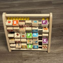 This is a wooden alphabet abacus