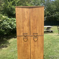 South Shore Morgan 4-Door Storage Cabinet in a Country Pine finish.