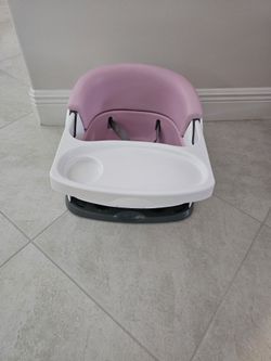 Ingenuity Baby Base 2-in-1 Booster Feeding and Floor Seat in the pink shade (often sold under colorway names like Peony or Pink Flambe).