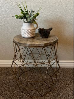 Accent table with a wood top & gold faux geometric wire base.