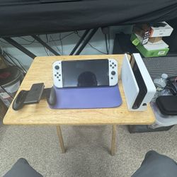 Nintendo switch OLED with joy con + 5 games and two additional controllers, docking station, and a protective carrying case