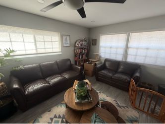 Brown leather couch and love seat