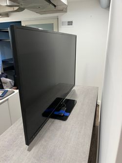 Black Flat Panel TV with Stand