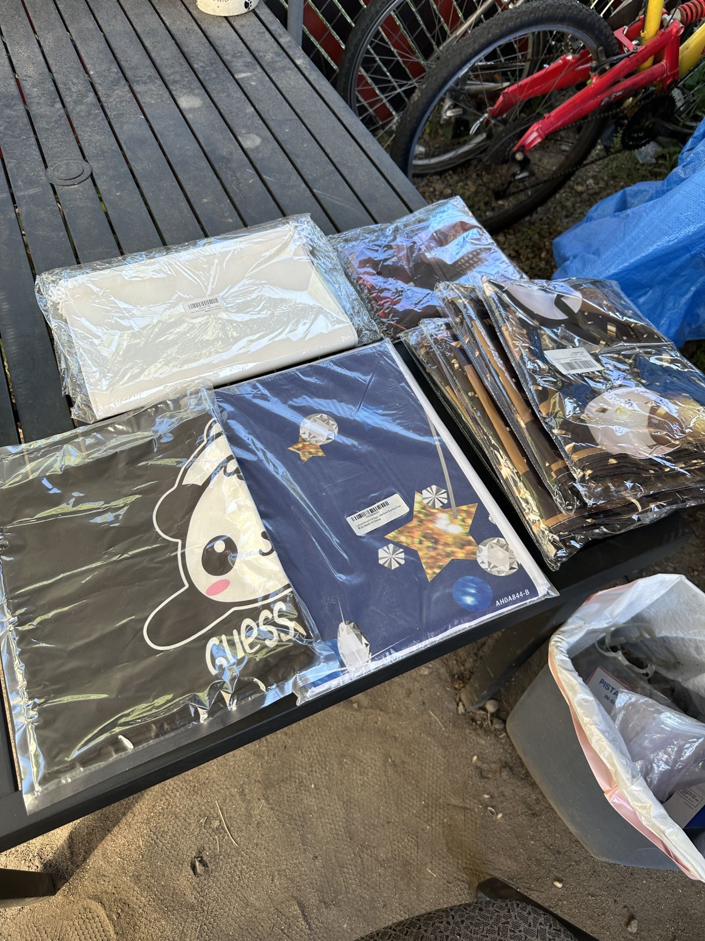 1 lot of unopened material. banners. table cloth. bags. photo booth backdrop