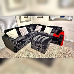 Black Jumbo corduroy sectional sofa with ottoman