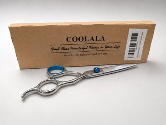 this is a pair of professional-grade, stainless steel hair-cutting shears resting in front of its original packaging.
​Key Featur
