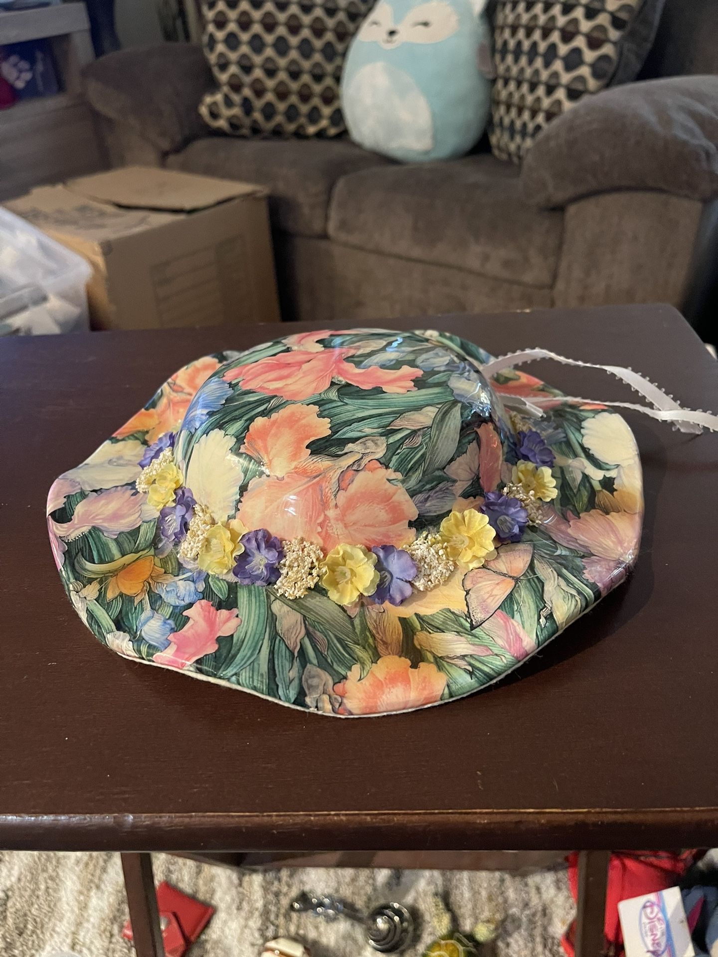 This ceramic piece is a decorative vintage-style wall hanging bonnet, a collectible item typically created by artists like Linda Edgington.