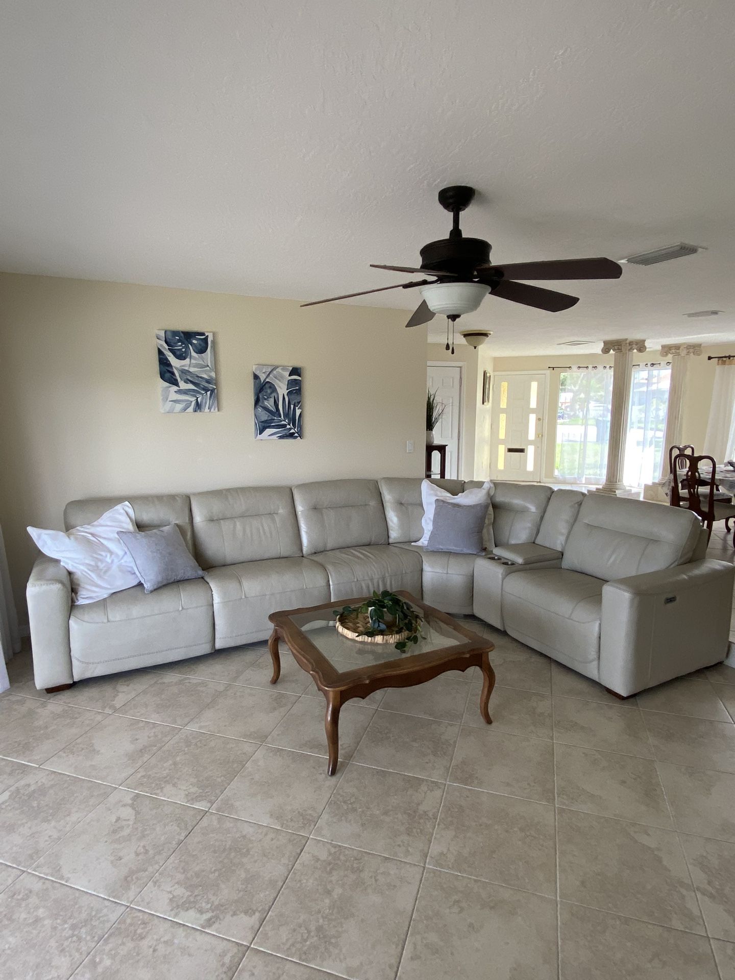 Like new electric leather sectional, dining room table, chairs and cabinet, treadmill for sale.