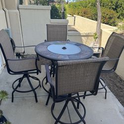 Bar heights table and 4 chairs that swivel. Plus umbrella stand