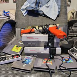 2 Nintendo NES consoles with controllers zapper gun and 11 games